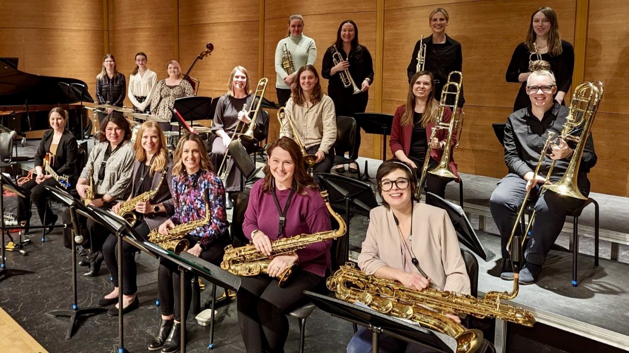 Group of 17 women jazz musicians with musical instruments.