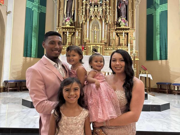 Family posing in a church setting.