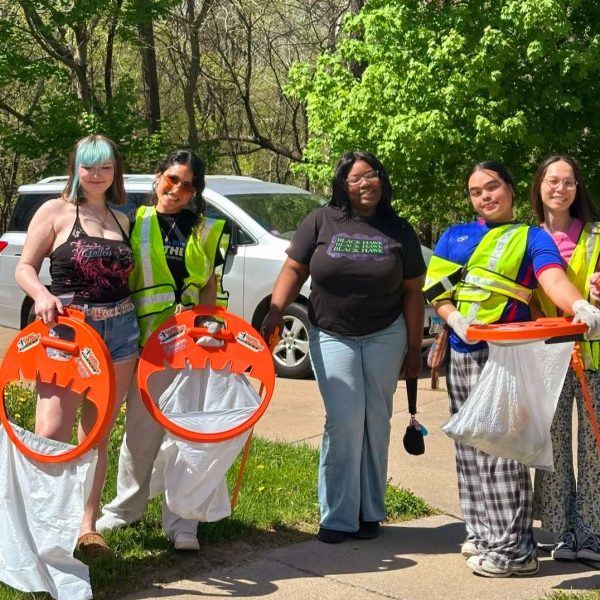 Group cleaning up outdoors together.
