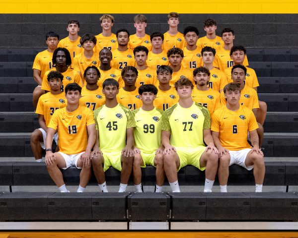 Men's soccer photo 2025-26. A group of men in soccer uniforms sit on bleachers.