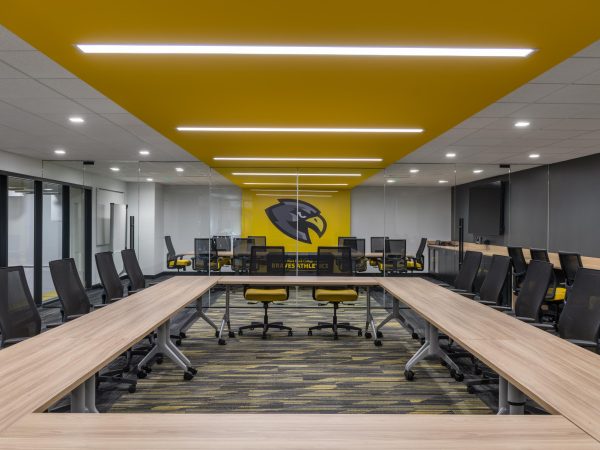 A room with a yellow ceiling and a table with chairs