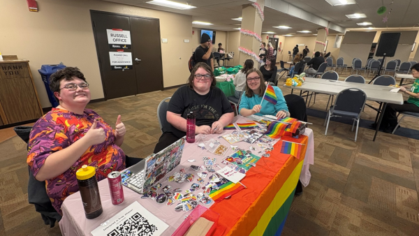 Jen and two members of the Pride Alliance sit at their table at Club Fest