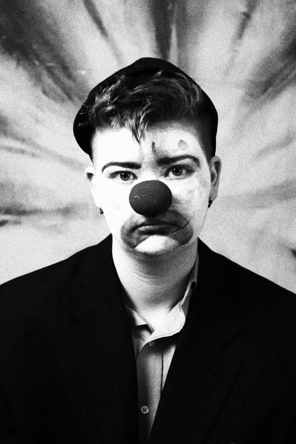 Art student prepares for uiuc transfer, career in media Sad clown with dramatic background.