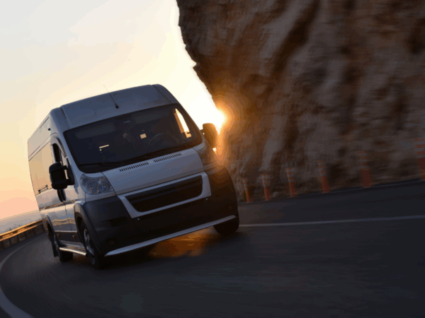 A white van driving on a road
