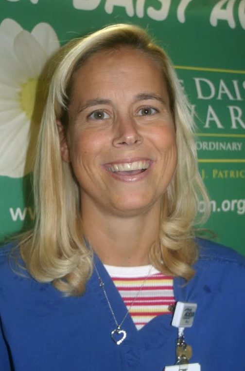 Bhc alum donates to help nursing students, program Head and shoulders shot of smiling woman wearing medical scrubs shirt.