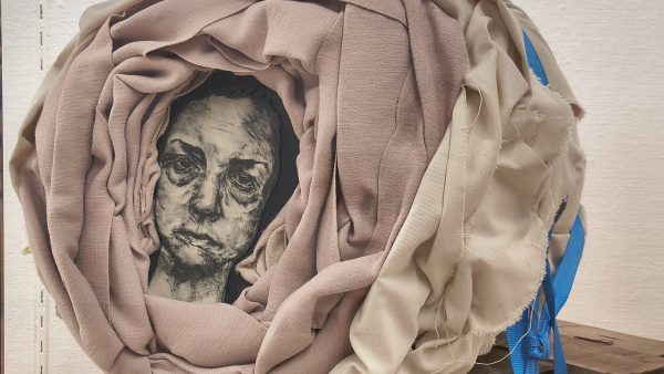 Artwork by sessah delarue made of found textile, image transfer and wood.
