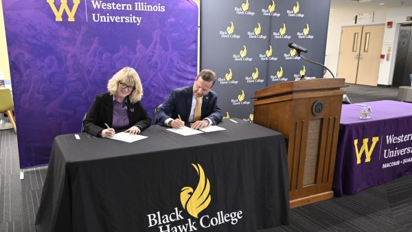 Dr. Kristi mindrup and dr. Jeremy thomas sign the articulation agreement during a press conference.
