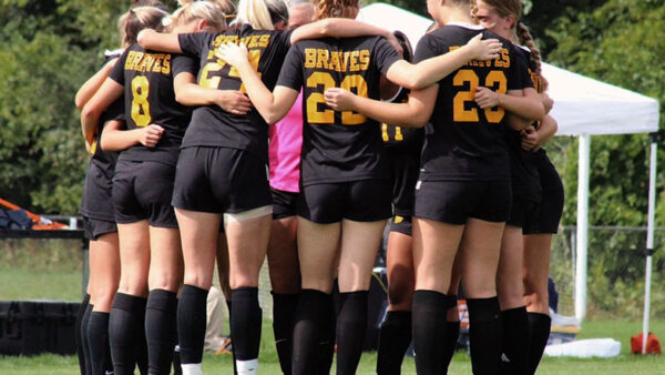 Women's soccer roster A group of children in a huddle