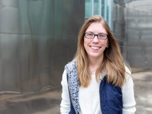Smiling student standing outside of a building