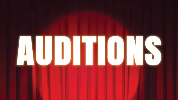 The word auditions on top of a stage theatre curtain and spotlight.