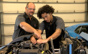 A couple of men working on a car