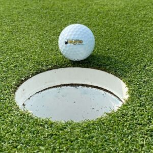 Bhc braves golf ball on edge of cup on the green