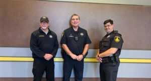Three male officers of the black hawk police department pose for a picture together.