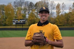 Baseball player in the black hawk college field