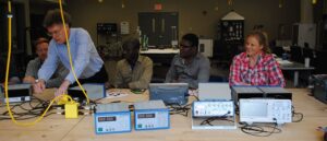 A group of men sitting at a table with computers