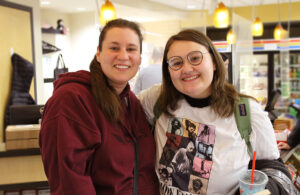 Mother and daughter pose for a photo in the black hawk bookstore.