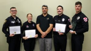 Seref onder with 4 police officers holding certificates & award