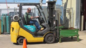 A person driving a forklift