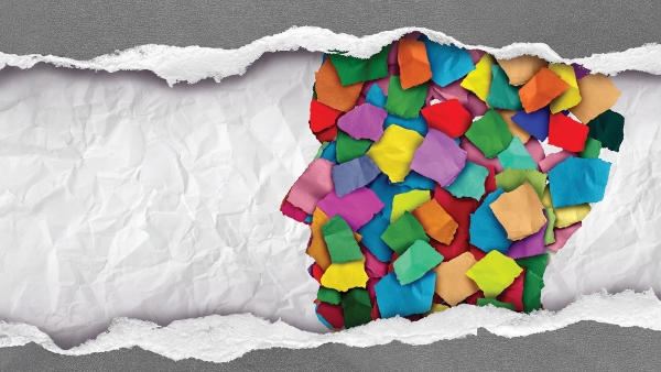 profile of head made from colorful torn pieces of paper with crumbled paper background