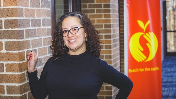 a person standing in front of a brick wall