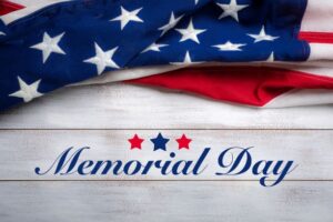 Text memorial day on white barnboard with flag
