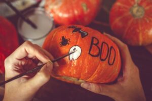 A person painting a pumpkin