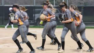 Softball players running across diamond