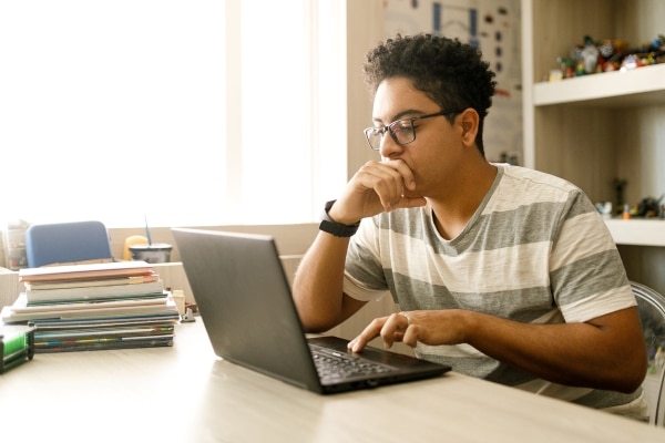 Student studying on laptop at home
