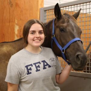 A person standing next to a horse